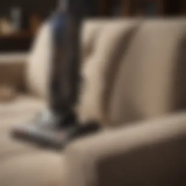 A vacuum cleaner equipped with upholstery attachment, ready for cleaning.